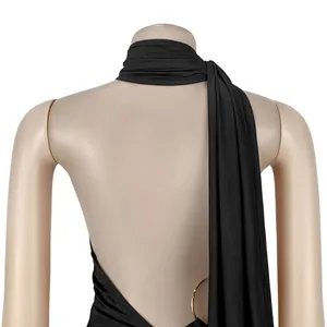 Macro view of sexy black backless jumpsuit showing golden metal ring detail on back