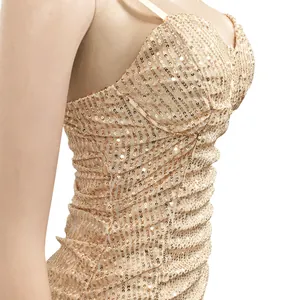 Close-up detail of champagne gold sequined evening dress with shimmering texture