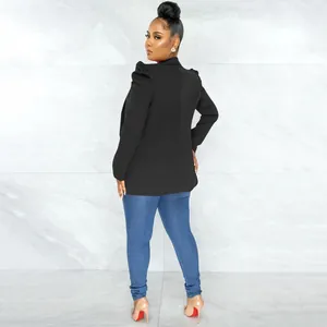 Back view of a black long-sleeved pleated blazer with puffed shoulders on a model.