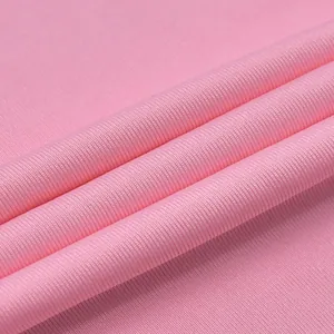 Close-up of pink ribbed knit fabric showing soft texture and fine vertical lines