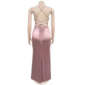 Detailed back view of a pink satin lace-up maxi dress featuring elegant cross-strap design