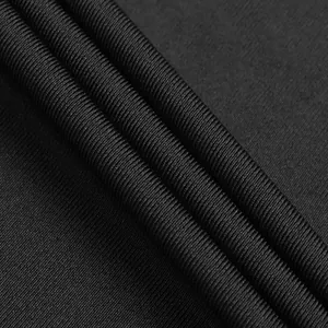 Close-up macro detail of high-quality black ribbed elastic fabric texture for fashion rompers