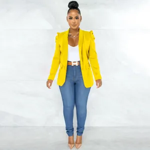 Detail view of a stylish vibrant yellow blazer featuring ruffled sleeves and a slim fit design