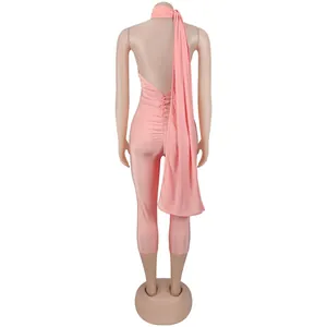 Sexy pink backless bodycon jumpsuit with halter neck and ruched back detail on mannequin