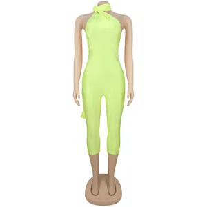 Detailed front view of a neon yellow halter neck skinny jumpsuit on a mannequin.