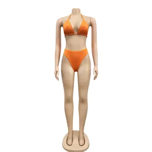 Detail view of a bright orange two-piece halter neck bikini set on a mannequin base