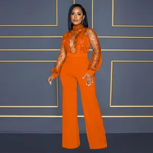 Combinaison orange élégante avec mesh à paillettes, manches longues et pantalon jambe large