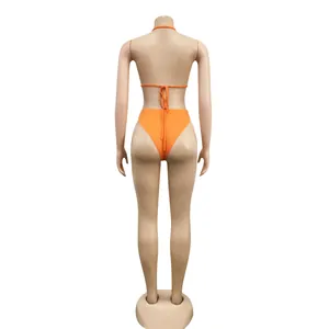 Detailed back view of a vibrant orange sexy bikini set displayed on a mannequin