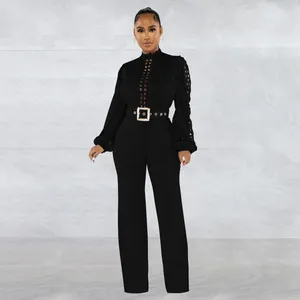 Elegant black long sleeve jumpsuit with delicate lace hollow details and belt