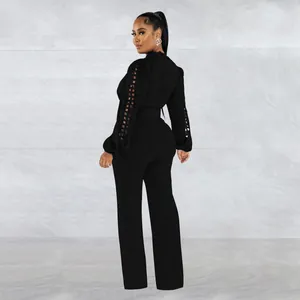Elegant black long sleeve jumpsuit featuring lace hollow-out sleeves and a matching waist belt