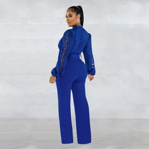 Rear side view showing lace hollow-out sleeve detail on a royal blue jumpsuit
