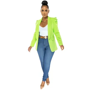 Detail view of stylish neon green blazer with puffed sleeves and elegant tailoring
