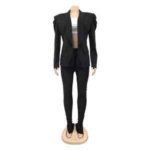 Detail view of stylish black pleated long sleeve blazer and matching slim fit pants