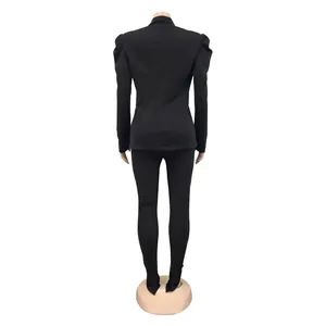 Back view of black women's fashion suit featuring a pleated puff sleeve blazer and pants