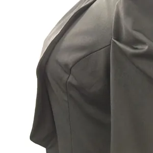 Detailed close-up showing shoulder pleats on a black solid color women's blazer jacket