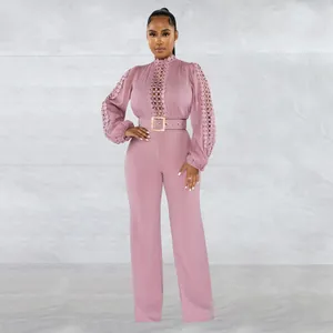 Full view of an elegant mauve hollow-out lace long sleeve jumpsuit with a gold buckle belt