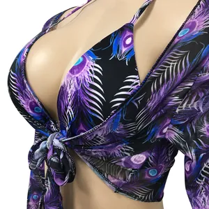Detailed view of three-piece peacock feather print bikini set with sheer mesh cover-up