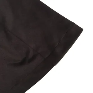 Close-up detail of black fabric texture and fine stitching on a modern women blazer