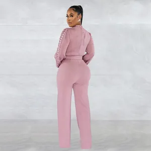 Back view of a mauve long-sleeve jumpsuit with lace hollow-out sleeves and belt