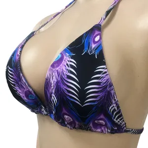 Close-up of a bikini top with vibrant purple and blue peacock feather print