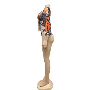 Side view of three-piece bikini set with colorful abstract print and mesh cover-up