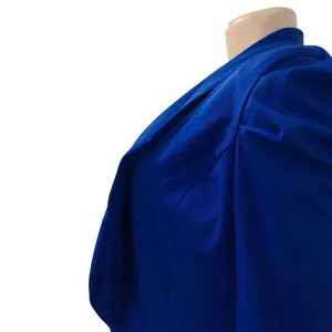 Close-up detail of royal blue pleated fabric on a fashionable women's long sleeve blazer