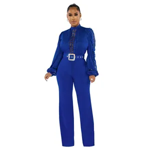 Elegant royal blue long sleeve jumpsuit with intricate lace hollow-out detail and belt.