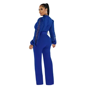Back view detail of royal blue jumpsuit featuring lace hollow out sleeves and waist belt