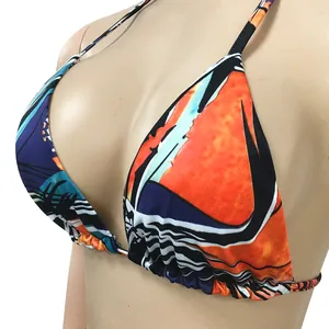 Close-up detail of sexy bikini top with vibrant abstract pattern on mannequin