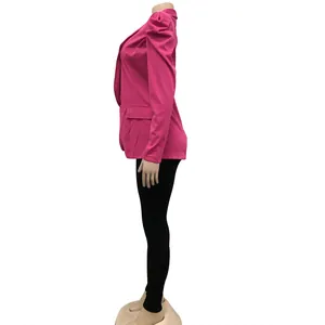 Side view of vibrant fuchsia blazer featuring pleated puff sleeves and notched lapels.