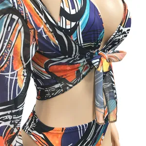 Detailed view of abstract print three-piece bikini set with sheer mesh tie-front top