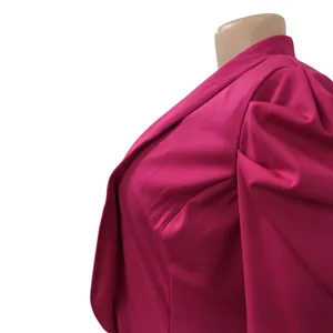 Close-up of elegant magenta pleated sleeve blazer detailing high-quality fabric texture.
