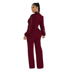 Back view of elegant burgundy long sleeve jumpsuit featuring lace hollow sleeves and belt