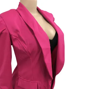 Detailed close-up view of a vibrant hot pink blazer featuring pleated shoulder design