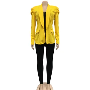 Detailed macro view of women's yellow long sleeve blazer with puff shoulder design