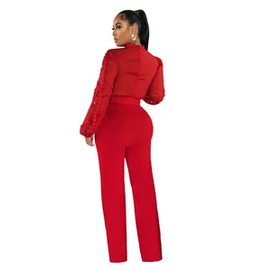 Back view of elegant red long-sleeve jumpsuit with lace hollow-out sleeves and belt