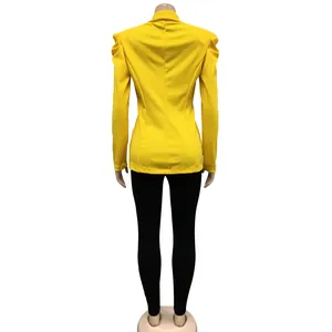 Back view of a vibrant yellow long-sleeved pleated blazer with padded shoulders on mannequin