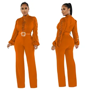 Elegant orange long sleeve jumpsuit with hollow-out lace details and matching belt view