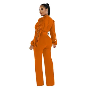Back view of orange long sleeve jumpsuit with delicate lace hollow sleeves and belt