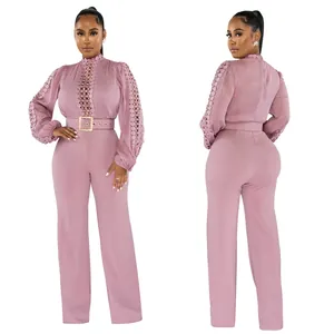 Front and back view of a pink hollow-out lace long sleeve jumpsuit with belt.