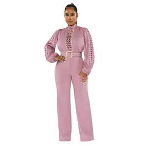 Close-up of lace hollow-out details and belted waist on a dusty rose jumpsuit