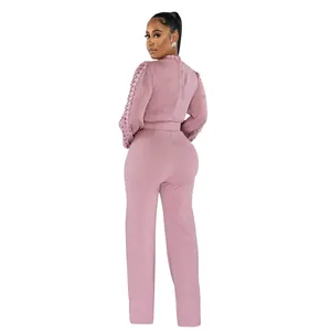 Elegant pink long sleeve jumpsuit with lace hollow sleeves and matching belt back view