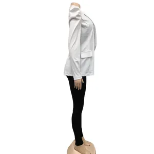 Side view of a white long-sleeved blazer with pleated puffed shoulders on a mannequin
