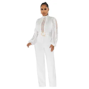 Detail of elegant white long sleeve hollow-out lace jumpsuit with gold buckle belt