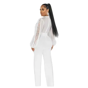 Back view of white elegant lace hollow long sleeve jumpsuit with belt