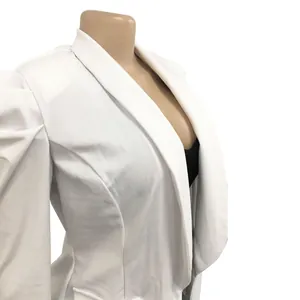 Detailed side view of a white woman's blazer featuring shawl collar and puff sleeves.