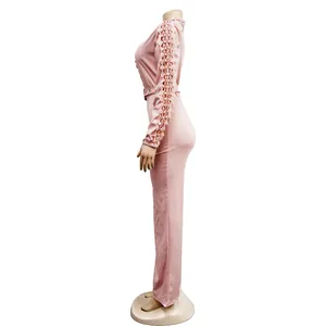 Side view of pink long sleeve jumpsuit with delicate lace hollow-out sleeve details