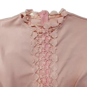 Detail showing the intricate hollow lace trim and back zipper on a pink fashion jumpsuit