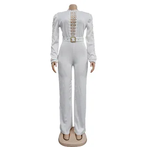Detailed view of white long-sleeved jumpsuit with lace hollow-out design and belt