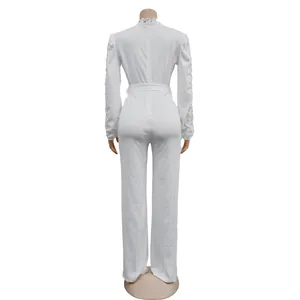 Elegant white long sleeve jumpsuit with lace hollow-out details and belt, back view.
